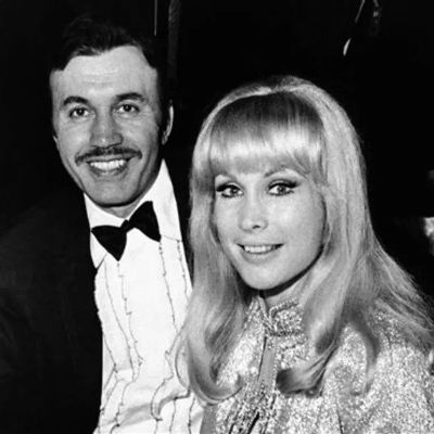 Michael Ansara is on a suit whereas Barbara Eden is wearing a glittery dress in this monochrome image.